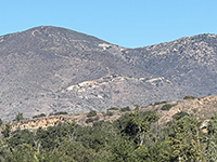 Zoom view of the tourmaline gem mines on Agua Tibia Mountain, west of the preserve.